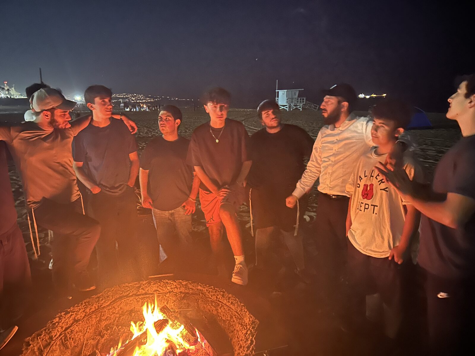 JHouse teens at a beach bonfire